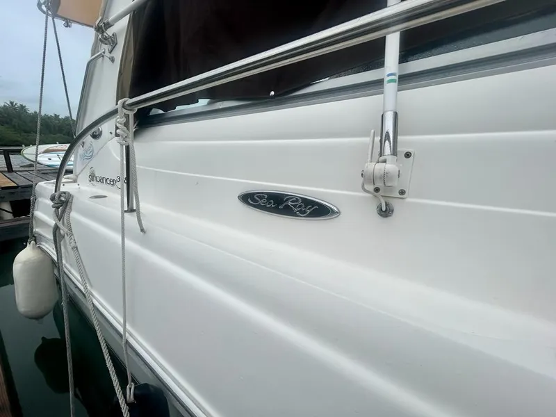 Slide: The Image of 2002 Sea Ray 340 Sundancer boat side view with logo and railing. - 3