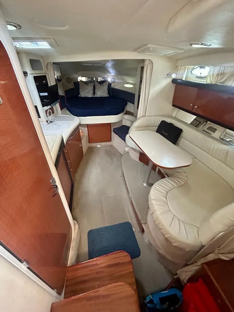 Slide: The Image of Interior of 2002 Sea Ray 340 Sundancer yacht with cozy seating and kitchenette. - 7