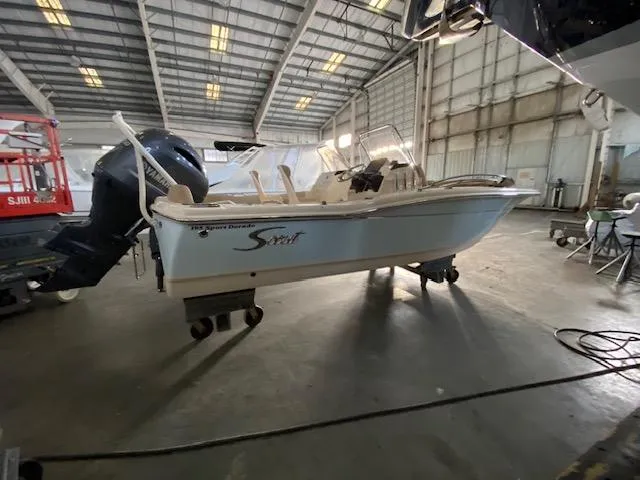 Slide: The Image of 2024 Scout 195 Sport Dorado boat in a warehouse setting. - 1