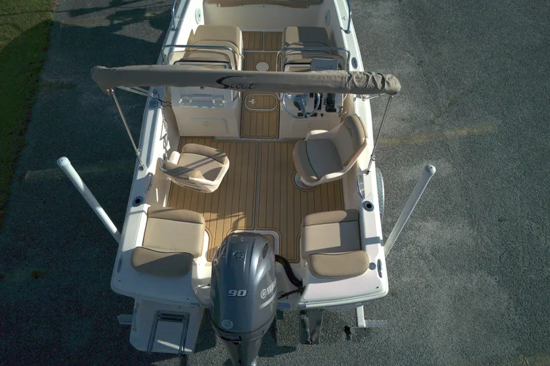 Slide: The Image of 2019 Scout 175 Dorado boat with Yamaha 90 engine, beige seating, and wooden deck. - 2