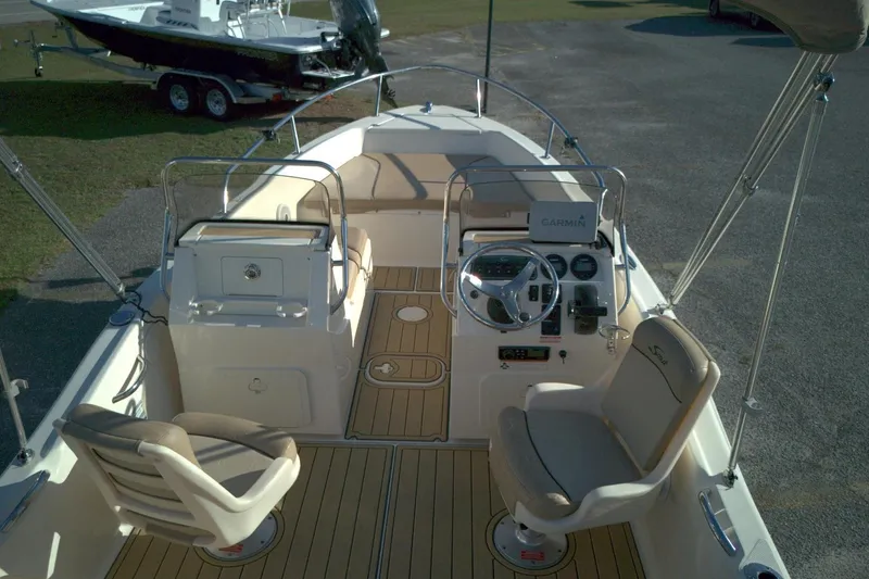 Slide: The Image of 2019 Scout 175 Dorado boat interior with steering console and seating. - 5