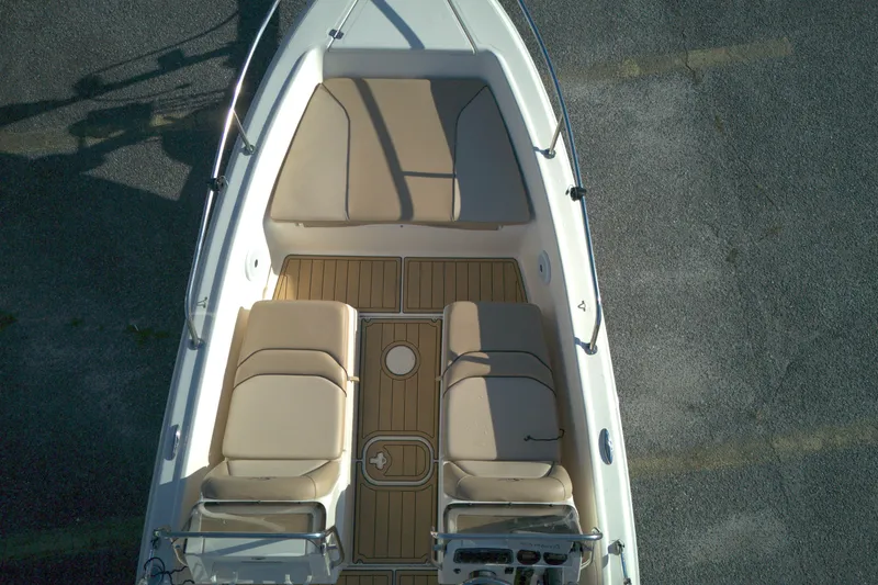 Slide: The Image of 2019 Scout 175 Dorado boat interior with beige seating and wooden flooring. - 7