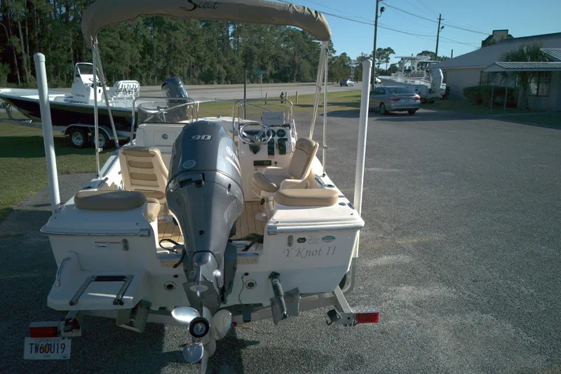 Slide: The Image of 2019 Scout 175 Dorado boat with outboard motor, parked outdoors. - 9