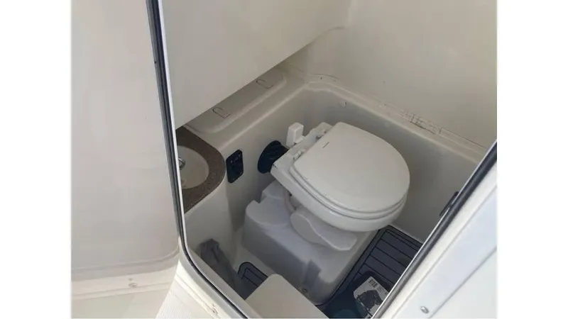 Slide: The Image of 2018 NauticStar 2800 XS boat interior bathroom with toilet - 12