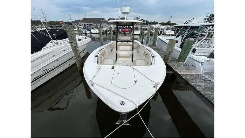 Slide: The Image of 2018 NauticStar 2800 XS boat docked at marina. - 13