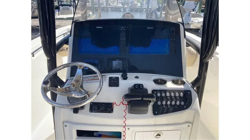 Slide: The Image of 2018 NauticStar 2800 XS boat dashboard with steering wheel and electronic displays. - 3