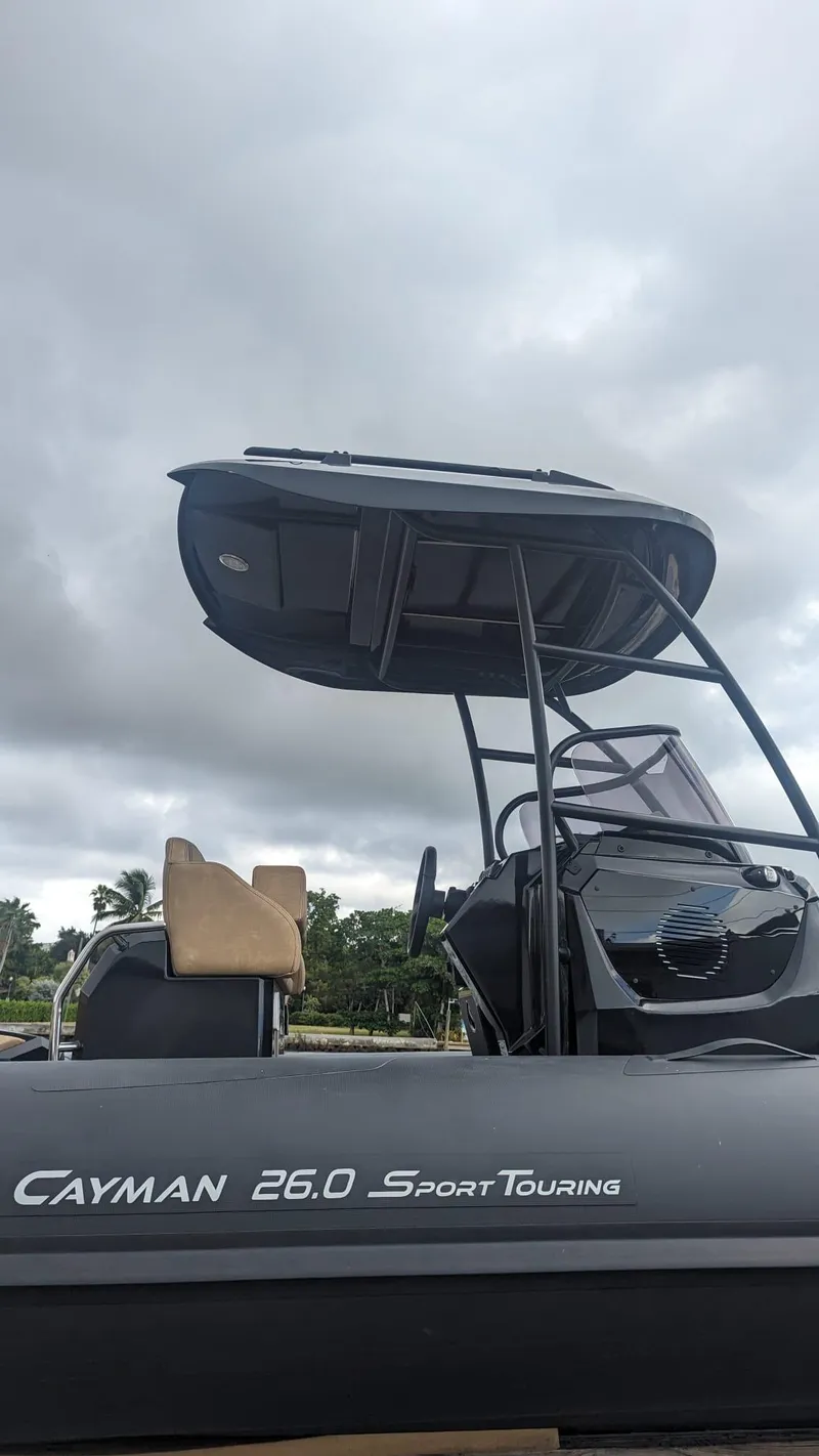 Slide: The Image of 2023 Ranieri CAYMAN 26 SPORT TOURING boat with canopy and console. - 21