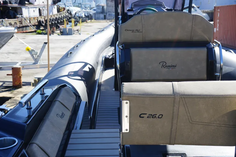 Slide: The Image of 2023 Ranieri CAYMAN 26 SPORT TOURING boat interior, docked at a marina. - 24