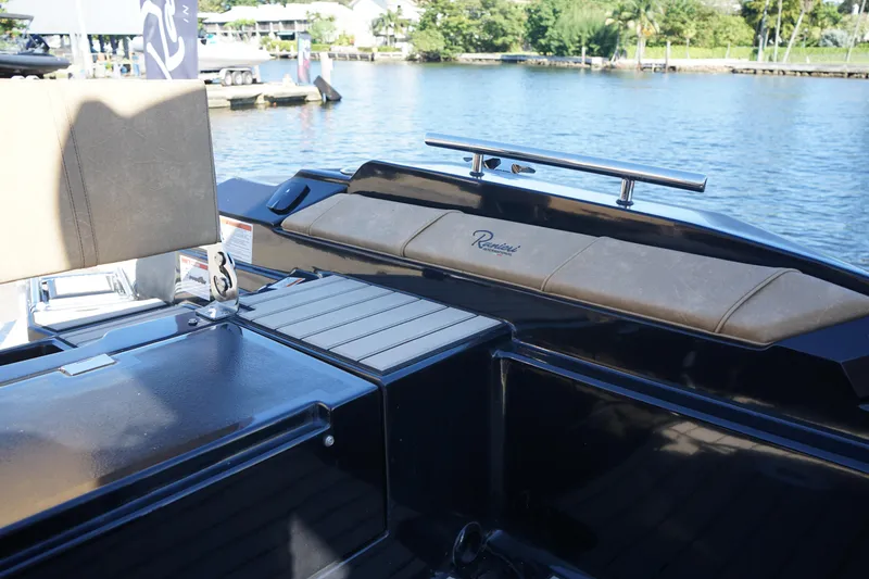 Slide: The Image of 2023 Ranieri CAYMAN 26 SPORT TOURING boat interior with seating and water view. - 26