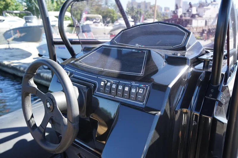 Slide: The Image of 2023 Ranieri CAYMAN 26 SPORT TOURING boat dashboard and steering wheel. - 27