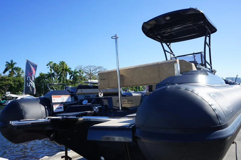 Slide: The Image of 2023 Ranieri CAYMAN 26 SPORT TOURING boat docked, rear view with clear blue sky. - 30