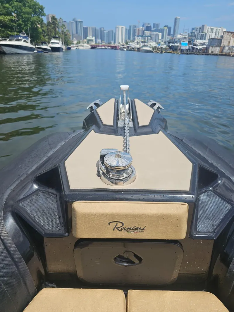 Slide: The Image of 2023 Ranieri CAYMAN 26 SPORT TOURING boat on water with city skyline in background. - 35