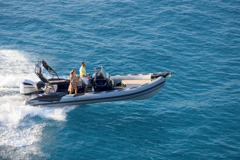 Slide: The Image of 2023 Ranieri CAYMAN 26 SPORT TOURING boat cruising on blue ocean water. - 7