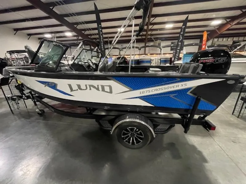 The Image of 2024 Lund 1875 Crossover XS Sport boat in showroom, side view. - 1