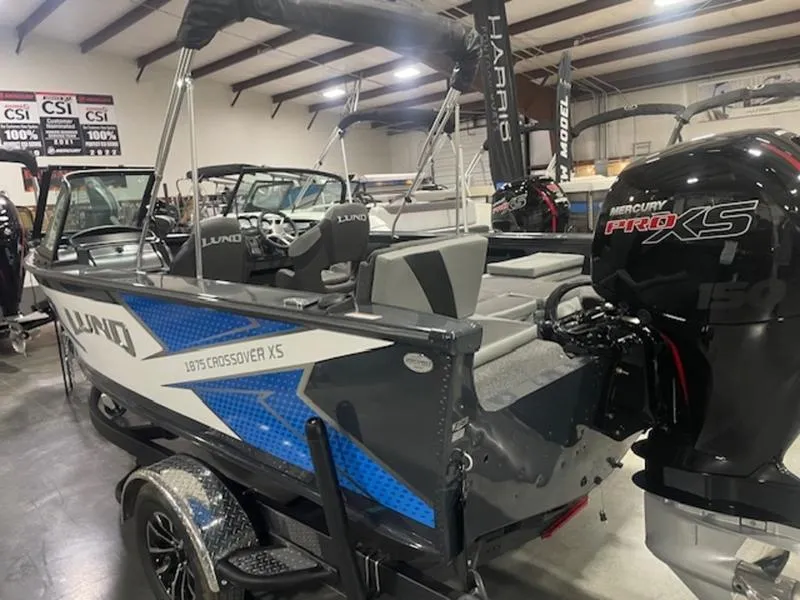 Slide: The Image of 2024 Lund 1875 Crossover XS Sport boat with Mercury Pro XS engine in showroom. - 3