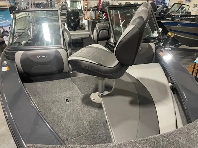 Slide: The Image of 2024 Lund 1875 Crossover XS Sport boat interior with seating and windshield. - 9