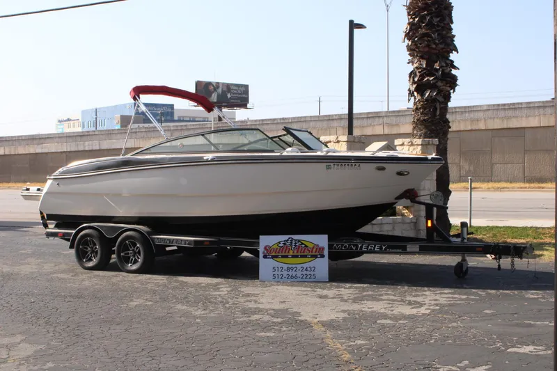The Image of 2013 Monterey 234 SS boat on trailer, parked outdoors near palm tree. - 1