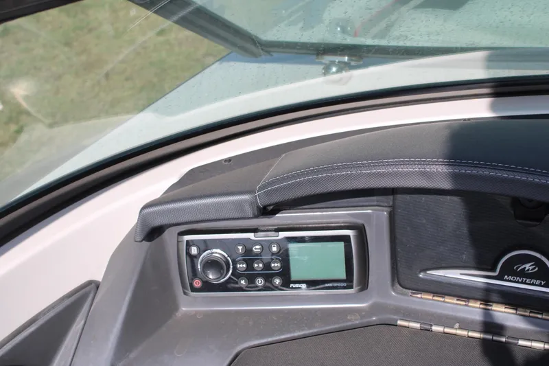 Slide: The Image of Dashboard of a 2013 Monterey 234 SS boat with audio controls. - 10