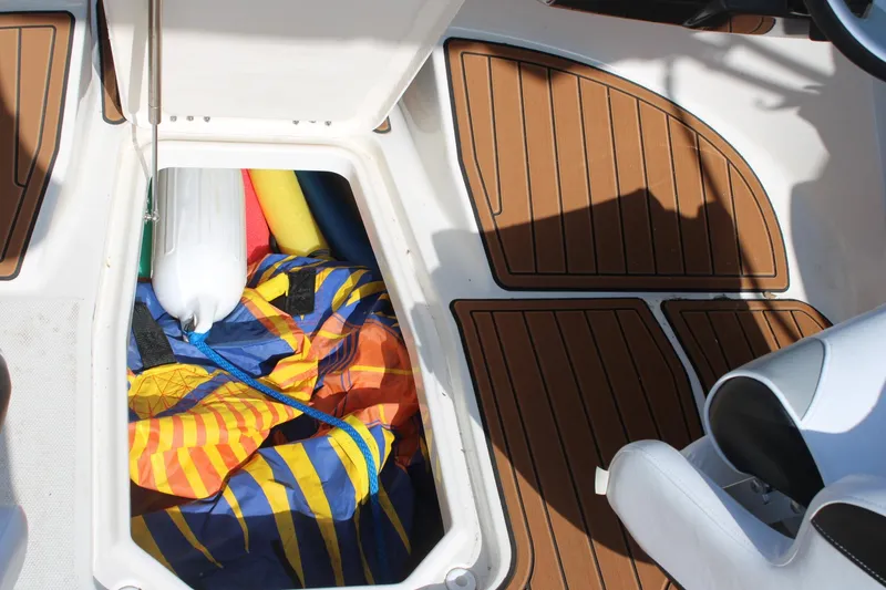 Slide: The Image of Storage compartment in 2013 Monterey 234 SS boat with colorful gear and fender. - 12