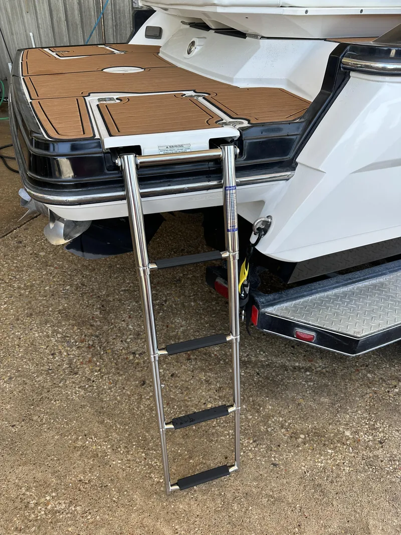 Slide: The Image of 2013 Monterey 234 SS boat with extended swim platform and ladder. - 2