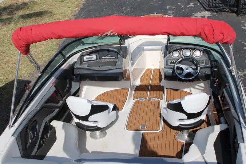 Slide: The Image of 2013 Monterey 234 SS boat interior with wood flooring and white seats. - 23