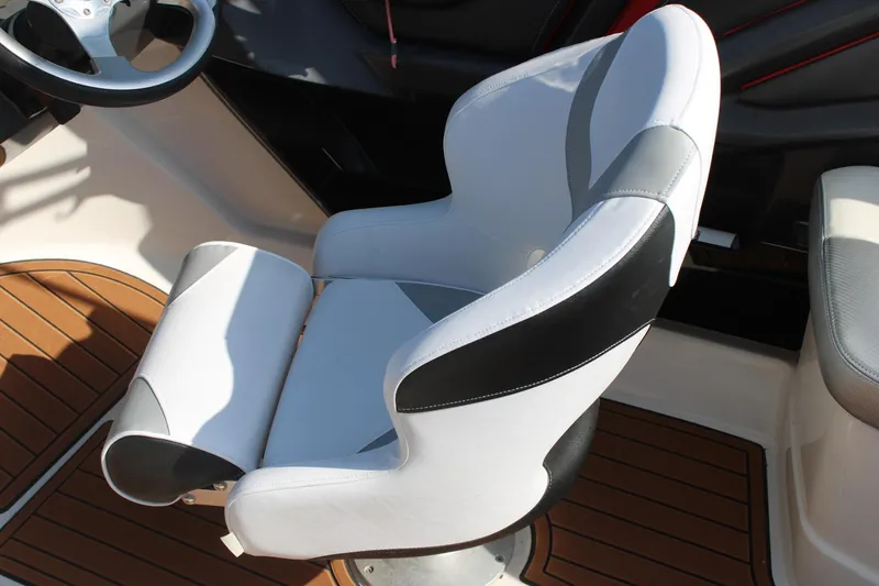 Slide: The Image of 2013 Monterey 234 SS boat interior with white and black captain's chair. - 29
