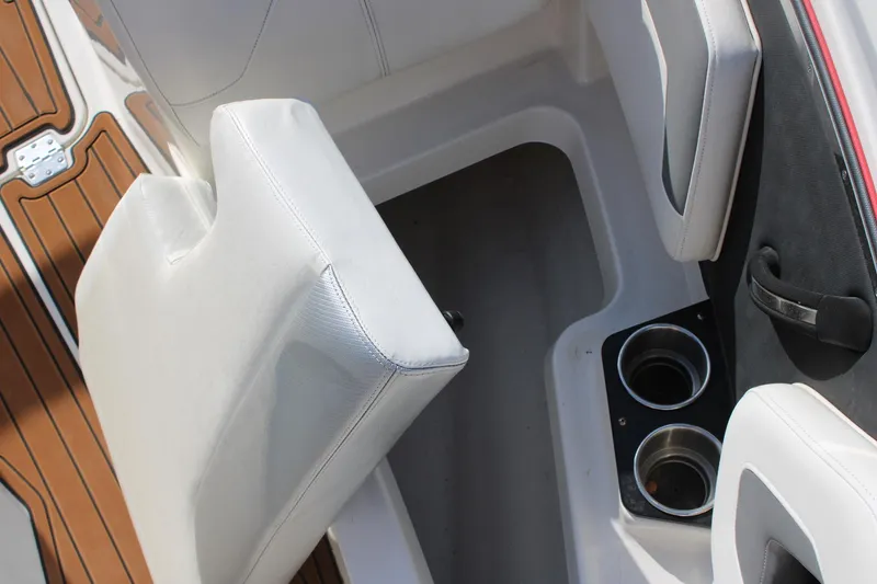 Slide: The Image of 2013 Monterey 234 SS boat interior with white seating and cup holders. - 16