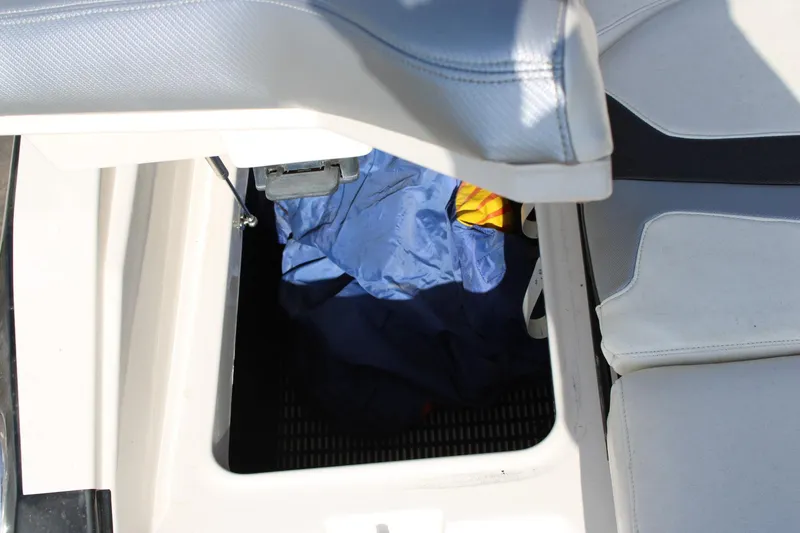 Slide: The Image of Open storage compartment in 2013 Monterey 234 SS boat with blue fabric inside. - 19
