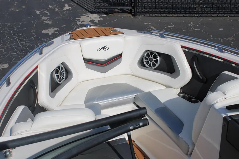 Slide: The Image of 2013 Monterey 234 SS boat interior with white seating and built-in speakers. - 24