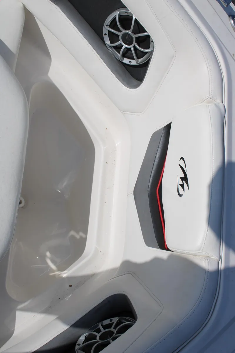 Slide: The Image of Interior of 2013 Monterey 234 SS boat with white seating and built-in speakers. - 26