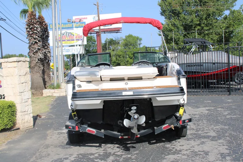 Slide: The Image of 2013 Monterey 234 SS boat on trailer, rear view, parked outdoors. - 5