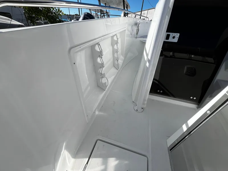 Slide: The Image of 2024 Jeanneau Leader 7.5 CC Series 3 boat interior with rod holders and storage compartments. - 29