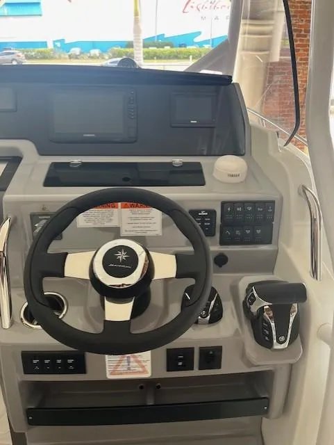 Slide: The Image of 2024 Jeanneau Leader 7.5 CC Series 3 helm with steering wheel and control panel. - 39