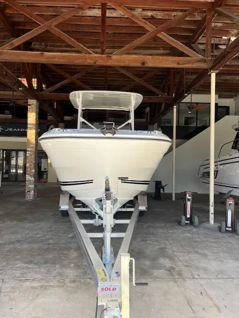 Slide: The Image of 2024 Jeanneau Leader 7.5 CC Series 3 boat on trailer in storage facility. - 1