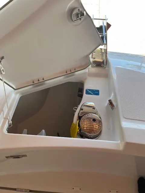 Slide: The Image of 2024 Jeanneau Leader 7.5 CC Series 3 boat storage compartment with open hatch. - 12