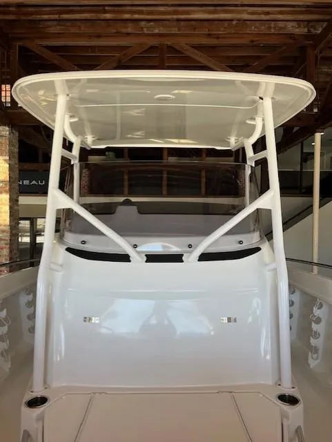 Slide: The Image of 2024 Jeanneau Leader 7.5 CC Series 3 boat, front view under a wooden roof. - 16