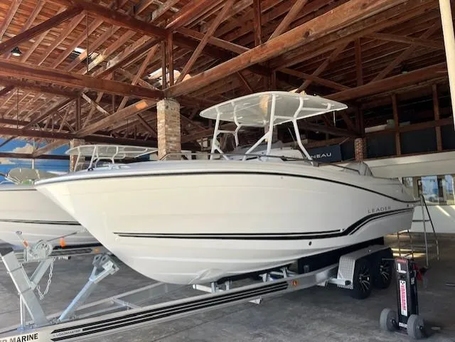 Slide: The Image of 2024 Jeanneau Leader 7.5 CC Series 3 boat on trailer in covered storage. - 2