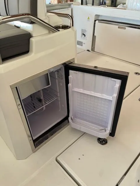Slide: The Image of 2024 Jeanneau Leader 7.5 CC Series 3 boat with open mini fridge in cockpit. - 23
