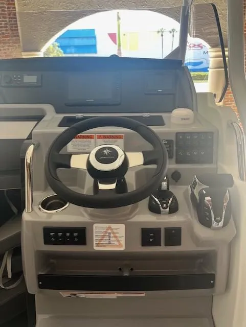 Slide: The Image of 2024 Jeanneau Leader 7.5 CC Series 3 boat helm with steering wheel and controls. - 7