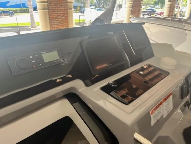 Slide: The Image of 2024 Jeanneau Leader 7.5 CC Series 3 dashboard with modern controls and navigation system. - 8