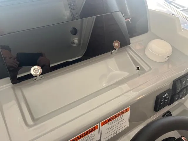 Slide: The Image of Dashboard of 2024 Jeanneau Leader 7.5 CC Series 3 boat with warning labels. - 9