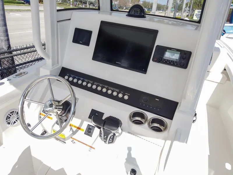 Slide: The Image of 2025 Regulator 23 Center Console boat dashboard with steering wheel and electronic controls. - 6