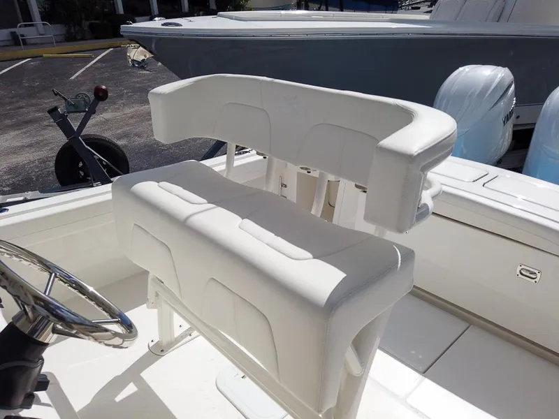 Slide: The Image of 2025 Regulator 23 Center Console boat with white cushioned seating. - 7