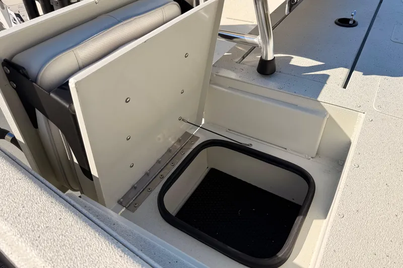 Slide: The Image of 2026 Ranger RB190 boat storage compartment with cushioned seat and open hatch. - 9