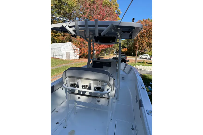 Slide: The Image of 2017 Century 2600 CC boat interior with helm and seating, surrounded by autumn foliage. - 10