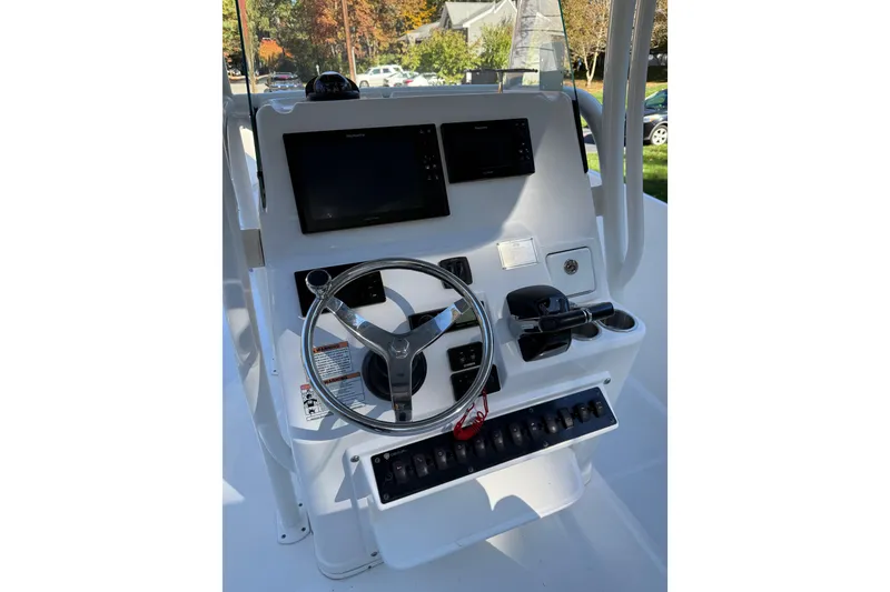 Slide: The Image of Steering console of a 2017 Century 2600 CC boat with navigation screens. - 12