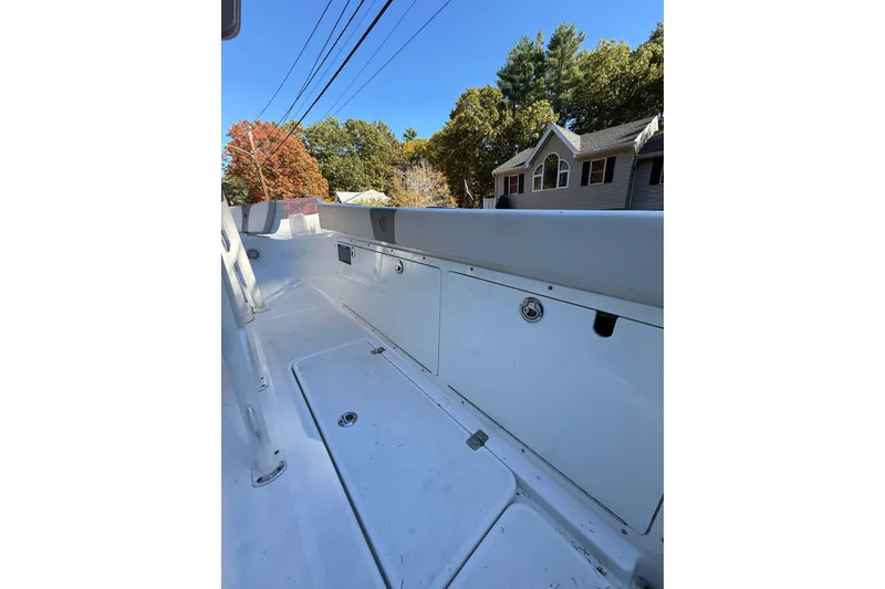 Slide: The Image of 2017 Century 2600 CC boat interior with storage compartments, outdoors in a residential area. - 15