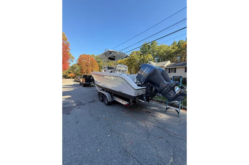 Slide: The Image of 2017 Century 2600 CC boat on trailer, parked on suburban street. - 4