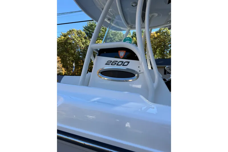 Slide: The Image of 2017 Century 2600 CC boat, white exterior, close-up view, outdoors with trees in background. - 8