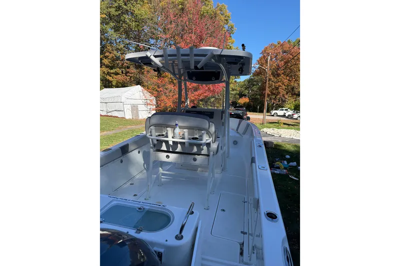 Slide: The Image of 2017 Century 2600 CC boat with T-top, parked outdoors in autumn setting. - 9